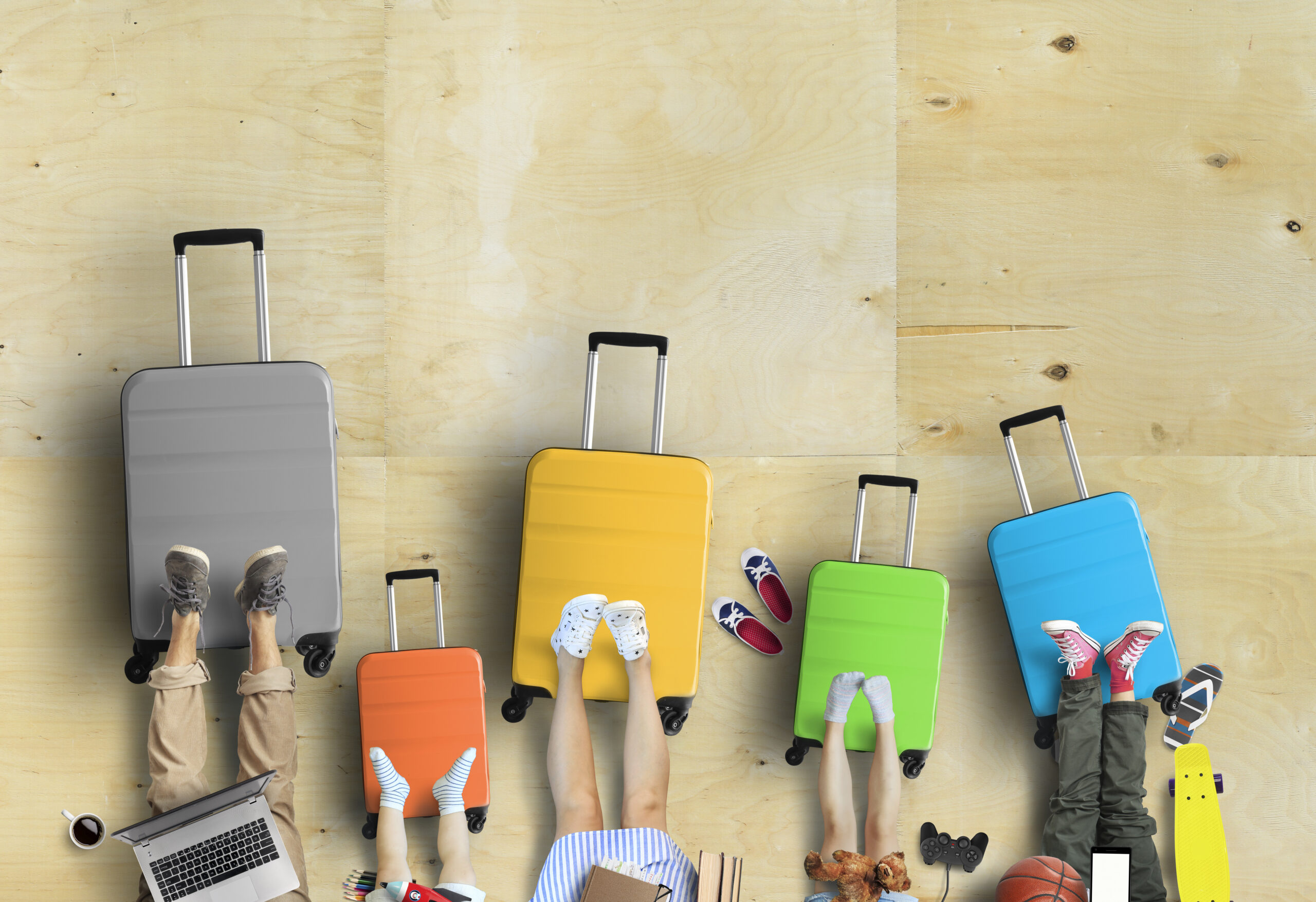 Family is going on a trip, five colored suitcases with clothes and accessories for recreation.